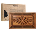 A rectangular teak wood shower mat with a diamond pattern design, displayed alongside its packaging box.